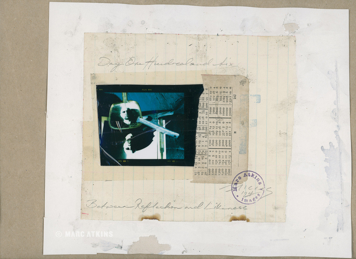 Small blue-toned image mounted over printed text and handwritten marks