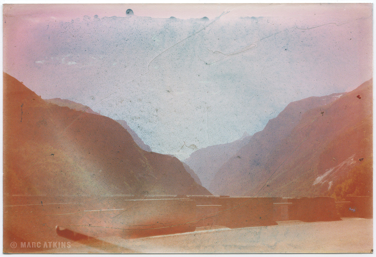 Mountain valley in muted pink, orange and blue tones