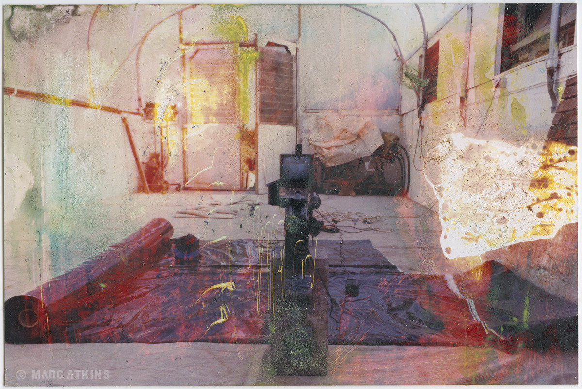 Layered studio interior with a chair, windows and coloured surfaces
